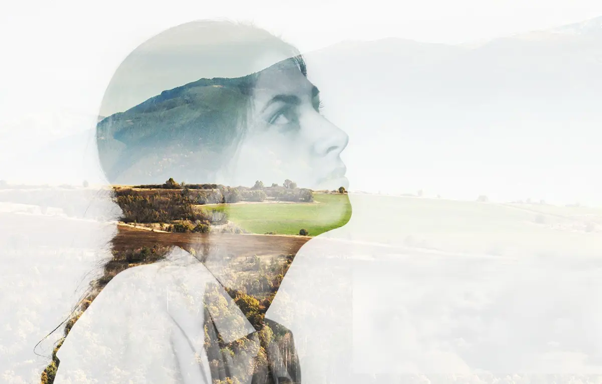 Multiple exposure image of a young woman contemplating against a serene mountain landscape, symbolizing inner transformation and self-discovery according to Gurdjieff's teachings on conscious self-development.