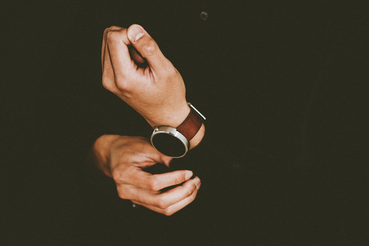 Person adjusting leather watch on wrist