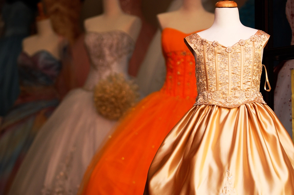 Elegant gold and orange gowns on display