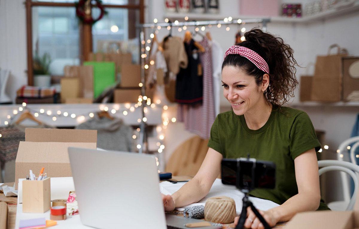 Woman working on laptop in craft store