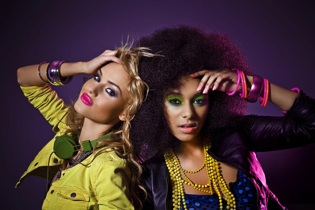 Two women in colourful 80s style fashion.