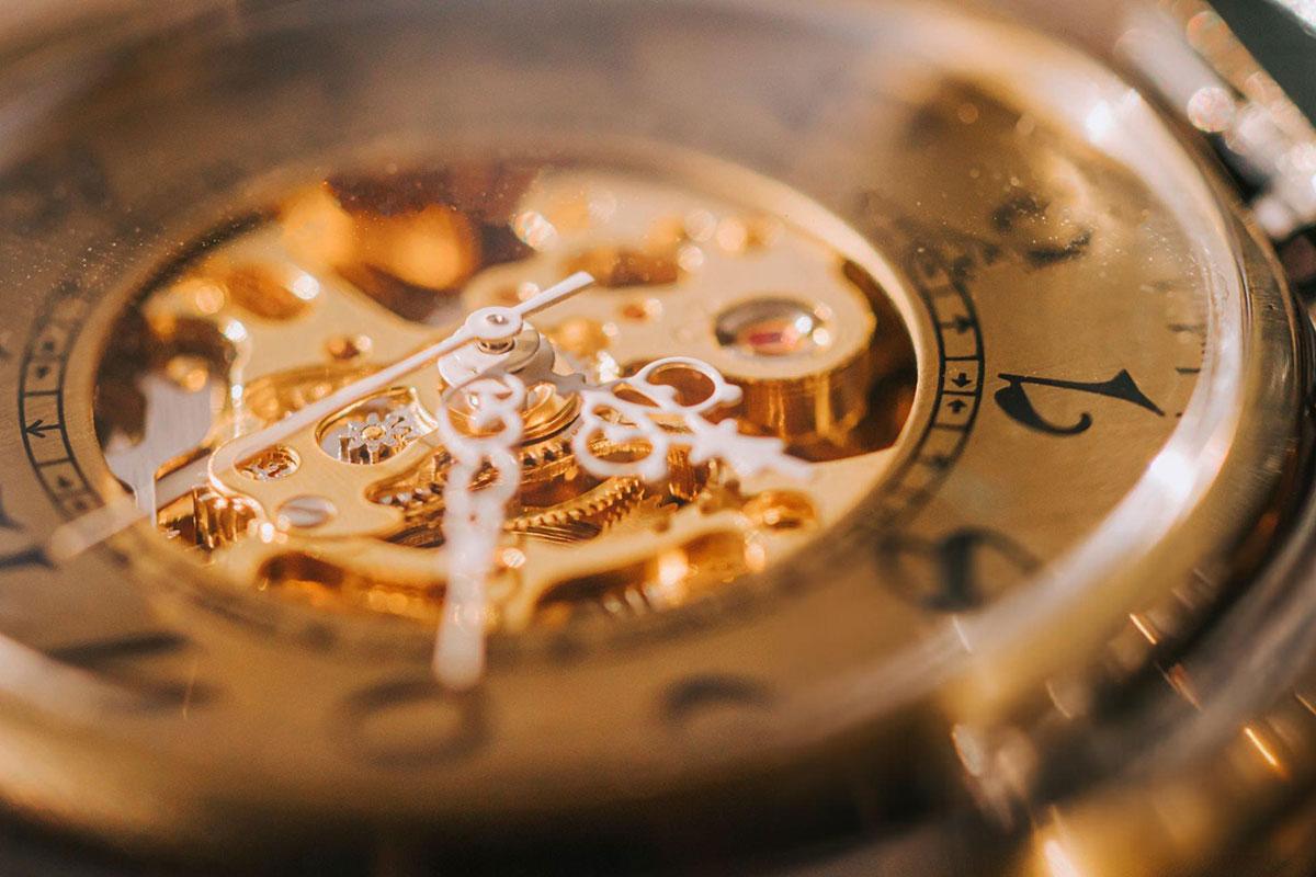 Close-up of ornate watch face and gears.