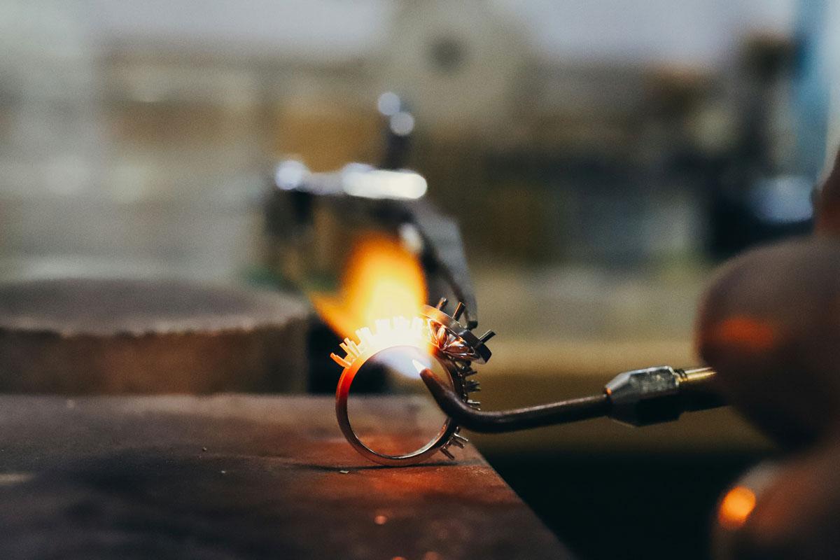 Jewellery soldering process with a torch flame.