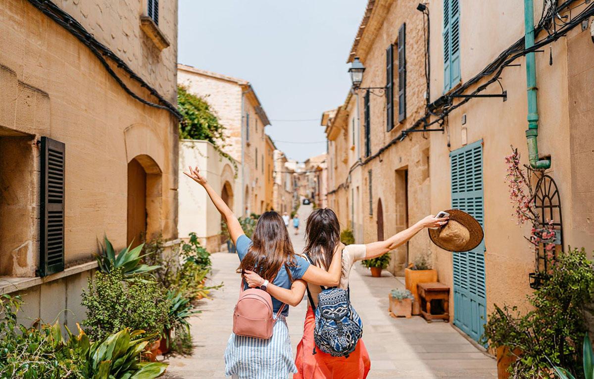 Friends exploring a picturesque European village street.