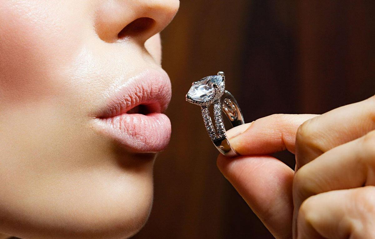 Close-up of a person admiring diamond ring.