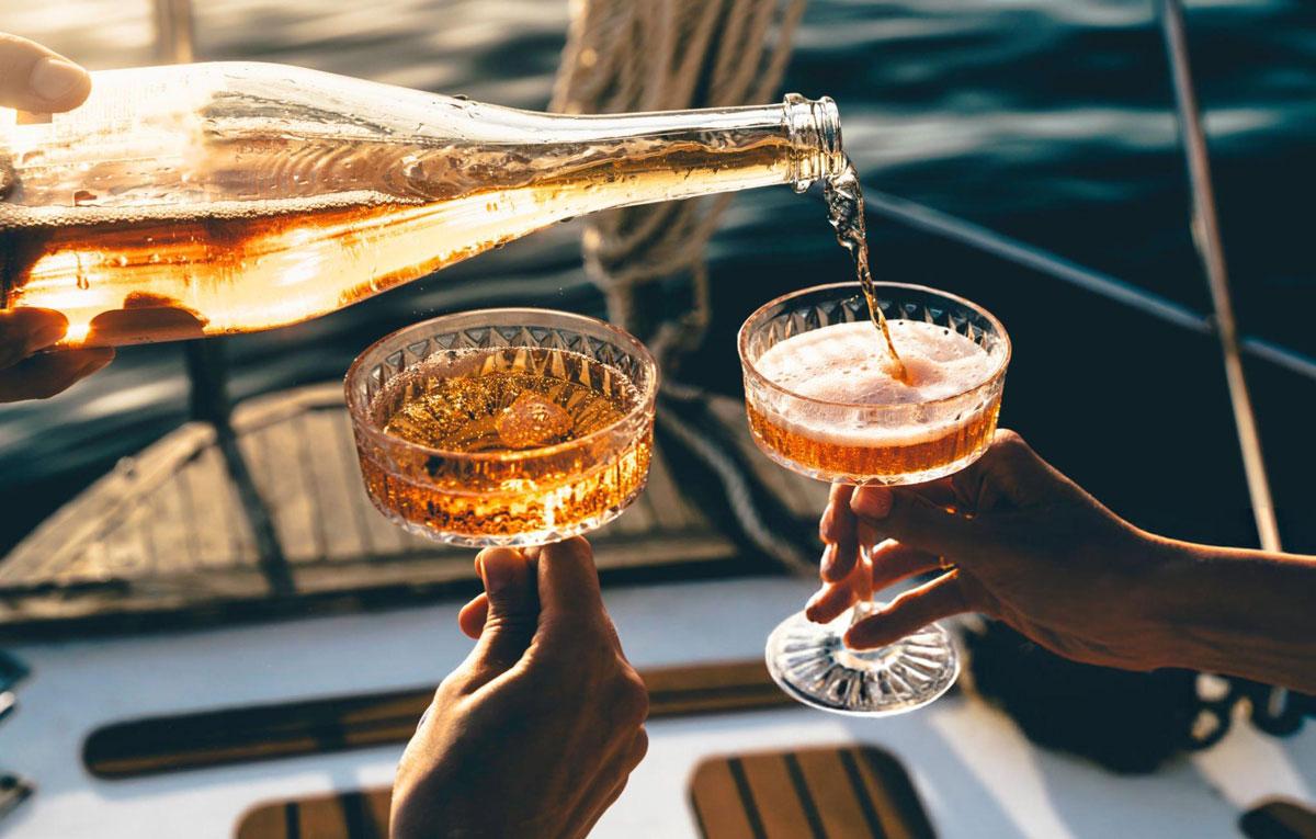 Pouring Champagne into glasses on a boat