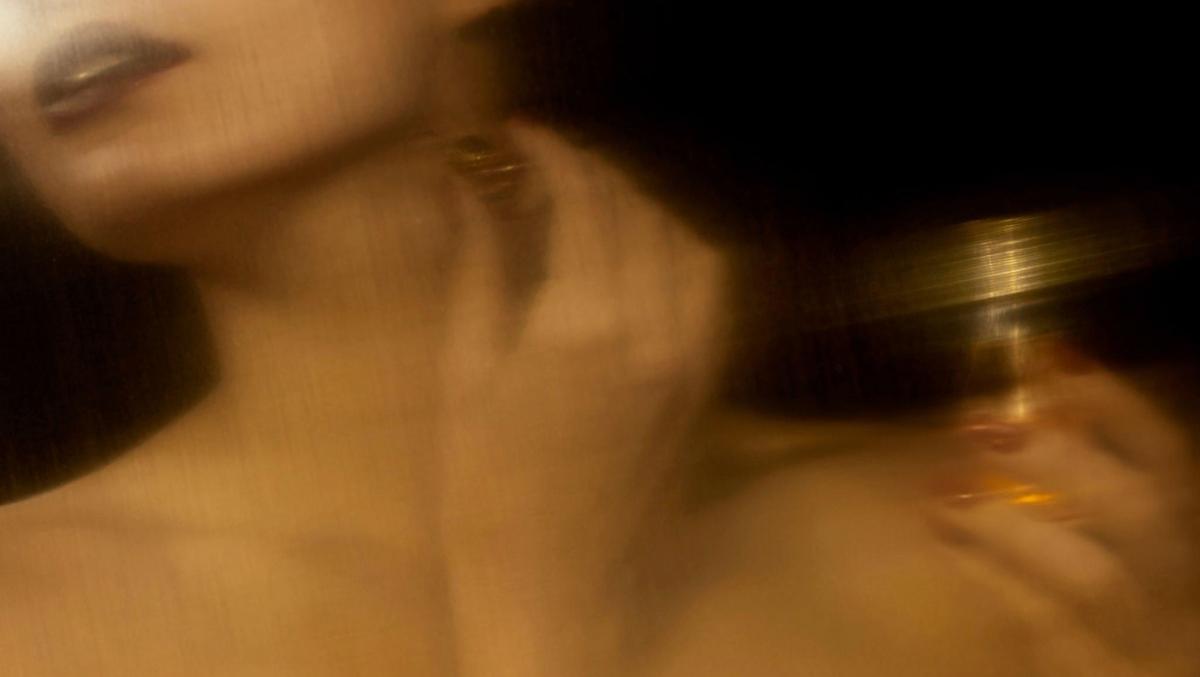 Abstract blurred woman applying makeup