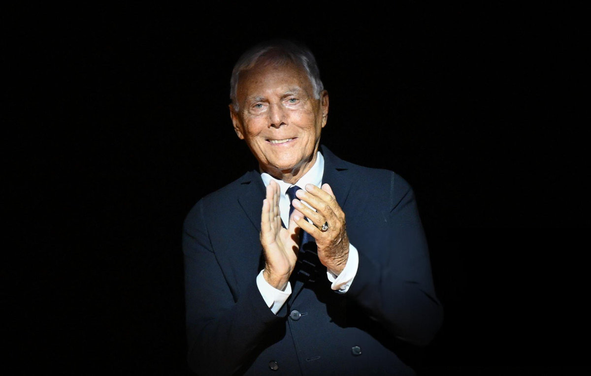 Giorgio Armani at a fashion event, wearing his signature tailored suit in his final years before his death in 2025