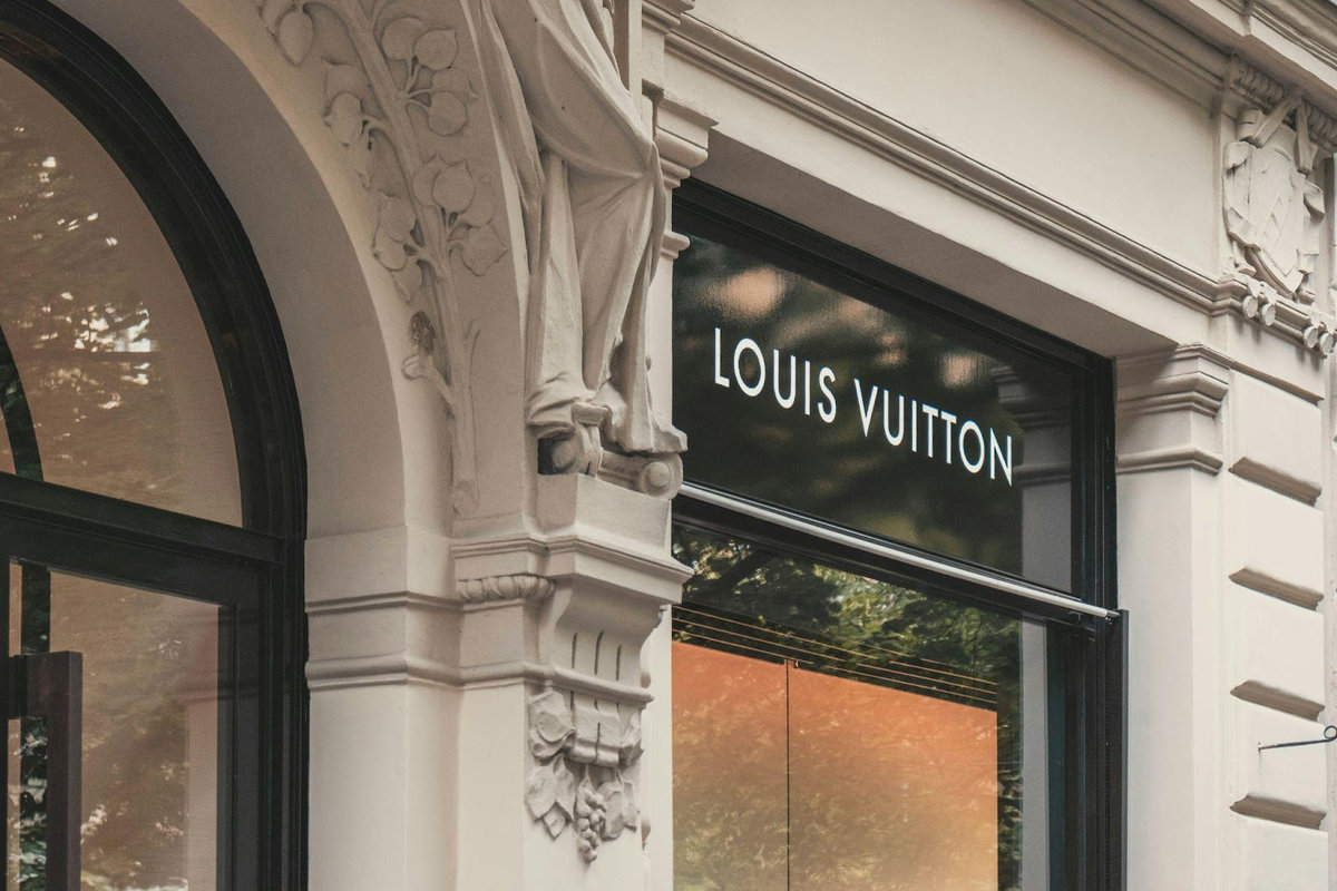 Louis Vuitton luxury retail storefront with ornate stone architecture, representing prestige careers in luxury fashion