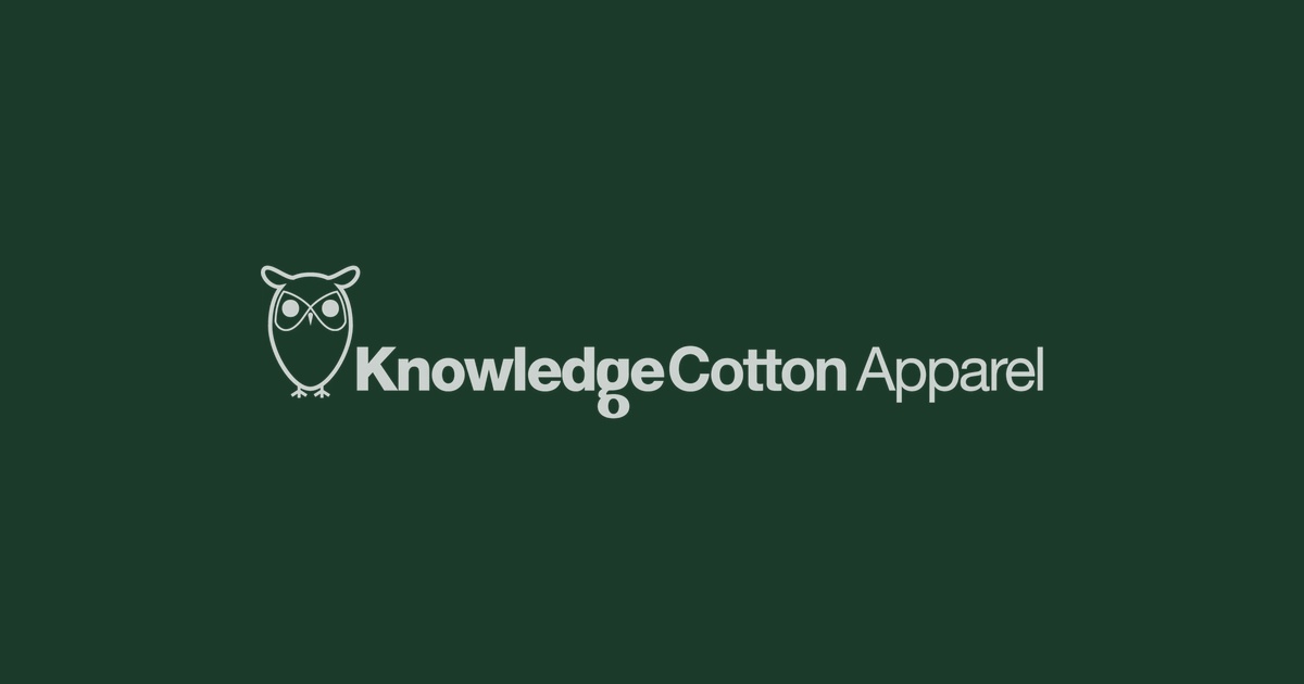 Knowledge Cotton Apparel logo on deep forest green background — Brand Check sustainability investigation by The Fashion Globe