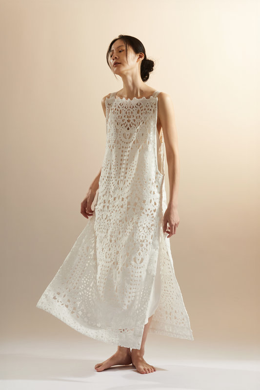 Wei i Hsieh Breaking Free metal perforations detail, geometric cutwork openings across draped fabric granting the bound body momentary respite