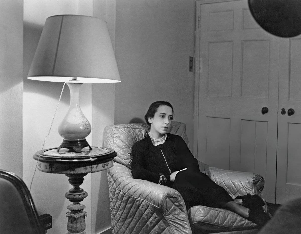 Elsa Schiaparelli seated in an armchair, photographed by Sasha, circa 1930s